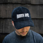 On-body front view of Rubber Bones Black Corduroy Dad Hat featuring embroidered logo.