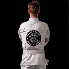 On-body shot of Inktober '21 Gi jacket featuring bold design, back view.