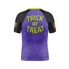 Back view of Rubber Bones Trick or Treat Kids BJJ rash guard with green slime-style “Trick or Treat” text on a purple background.