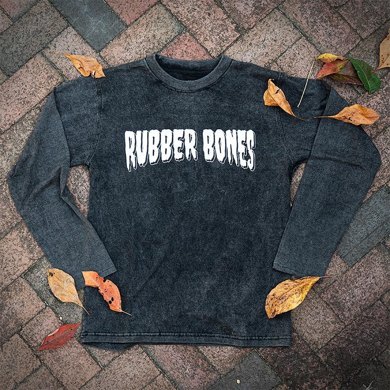 Black Long Sleeve Acid Wash T-Shirt laid flat with white Rubber Bones logo on the front.