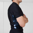 Side view of the Men’s Ash BJJ Rash Guard highlighting gray marble print panels and athletic fit.