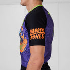 Side view of Trick or Treat rash guard showing orange Rubber Bones logo on sleeve.