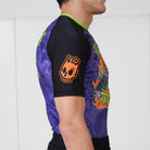 Side view of Trick or Treat rash guard showing orange Rubber Bones skull logo on sleeve.