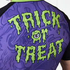 Back of rash guard with dripping green “Trick or Treat” text and eyeball detail.
