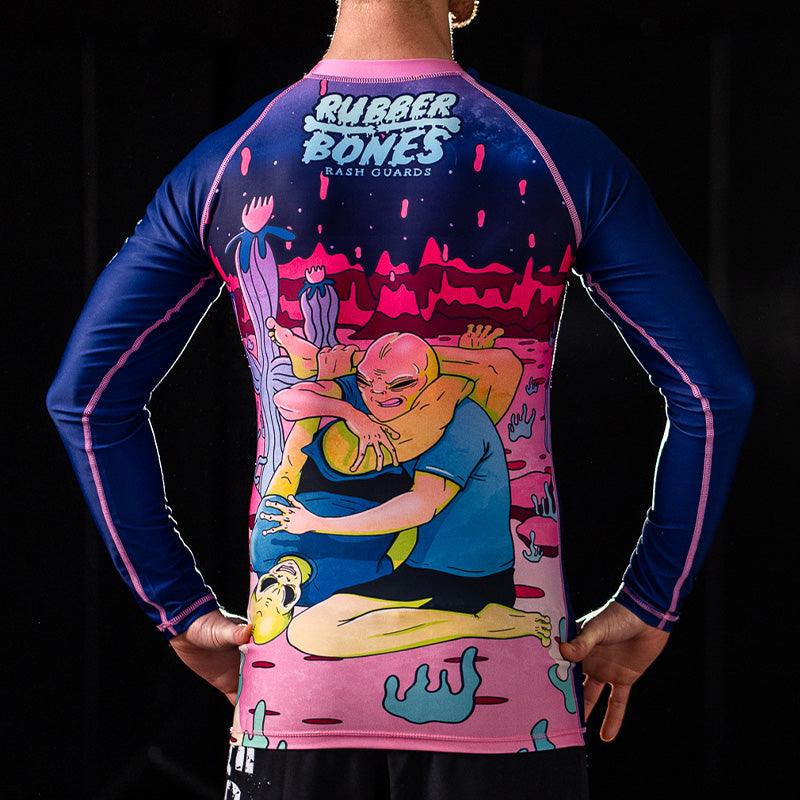 On-body back view of Invasion Long Sleeve Rash Guard highlighting alien-inspired artwork.