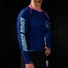 On-body male 3/4 view of Invasion Long Sleeve Rash Guard featuring bold alien and UFO designs.