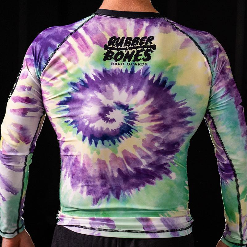 On-body back view of Legalize Leg Locks Long Sleeve Rash Guard featuring vibrant tie-dye artwork.