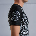 On-body sleeve detail view of Ranked Rash Guard - Black showcasing Rubber Bones logo
