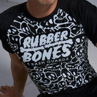 On-body close-up front detail view of Ranked Rash Guard - Black featuring skull web pattern and IBJJF-approved style.