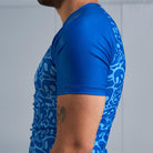 On-body side view of Ranked Rash Guard - Blue sleeve with blank solid blue design.