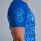 On-body side view of Ranked Rash Guard - Blue sleeve showing Rubber Bones logo on solid blue sleeve.