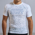 On-body front view of Ranked Rash Guard - White with monochromatic skull web design.