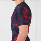 Side view of the Ember Men’s BJJ Rash Guard highlighting the athletic fit and red-black pattern.