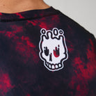 Close-up of the white melting skull Rubber Bones logo printed on the back of the Ember BJJ Rash Guard.
