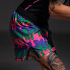 Close up of the Bubble Gum Grappling Shorts dripping bold pink, purple, green, and black design for Brazilian Jiu Jitsu.