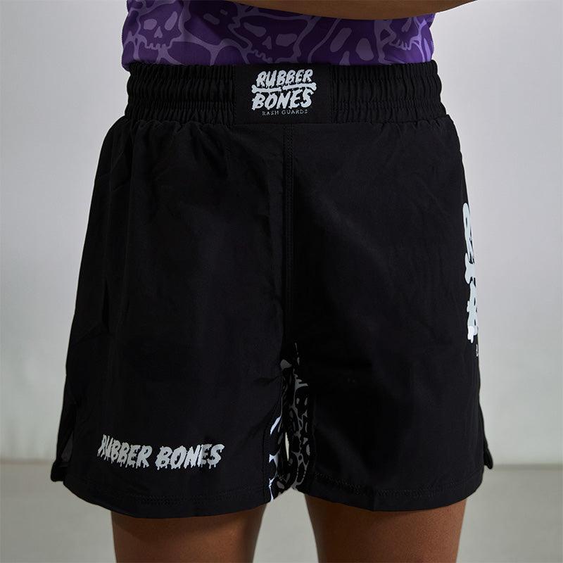 On-body shot of Competition Grappling Shorts, black and white IBJJF-approved shorts, front view.
