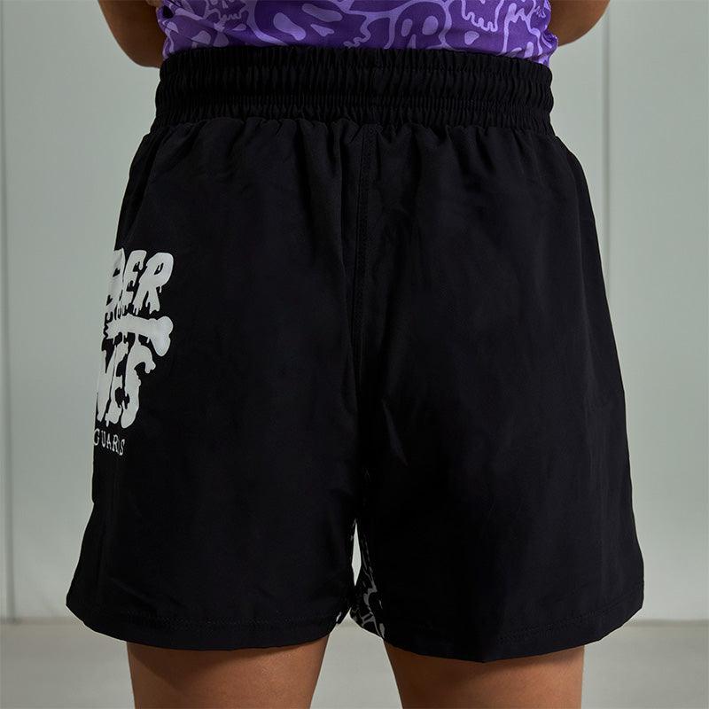On-body shot of Competition Grappling Shorts, black and white IBJJF-approved shorts, back view.