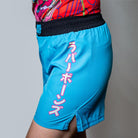 On-body side view of the blue Hannya Drip Grappling Shorts showing sleek design and reinforced side vents.