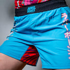 On-body shot of the blue Hannya Drip Grappling Shorts with bold, Hannya-inspired design, front view.