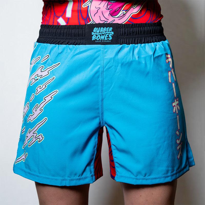 On-body shot of the blue Hannya Drip Grappling Shorts with bold, Hannya-inspired design, front view.