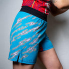 On-body side view of the blue Hannya Drip Grappling Shorts showing sleek design and reinforced side vents.