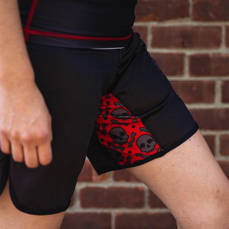 On-body side view of OG 2.0 Velcro Grappling Shorts showing bold skull pattern design.