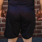 On-body back view of OG 2.0 Velcro Grappling Shorts featuring skull pattern and durable construction.