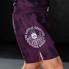 On-body side view of The Natural Grappler Grappling Shorts highlighting the natural grappler artwork.