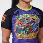 Close-up of Rubber Bones Trick or Treat rash guard artwork featuring colorful zombie and skeleton grapplers surrounded by flames.