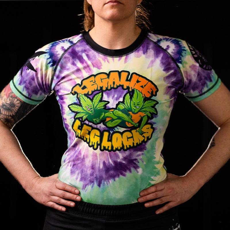 On-body front view of Women's Legalize Leg Locks Short Sleeve Rash Guard highlighting the fit and tie-dye design.