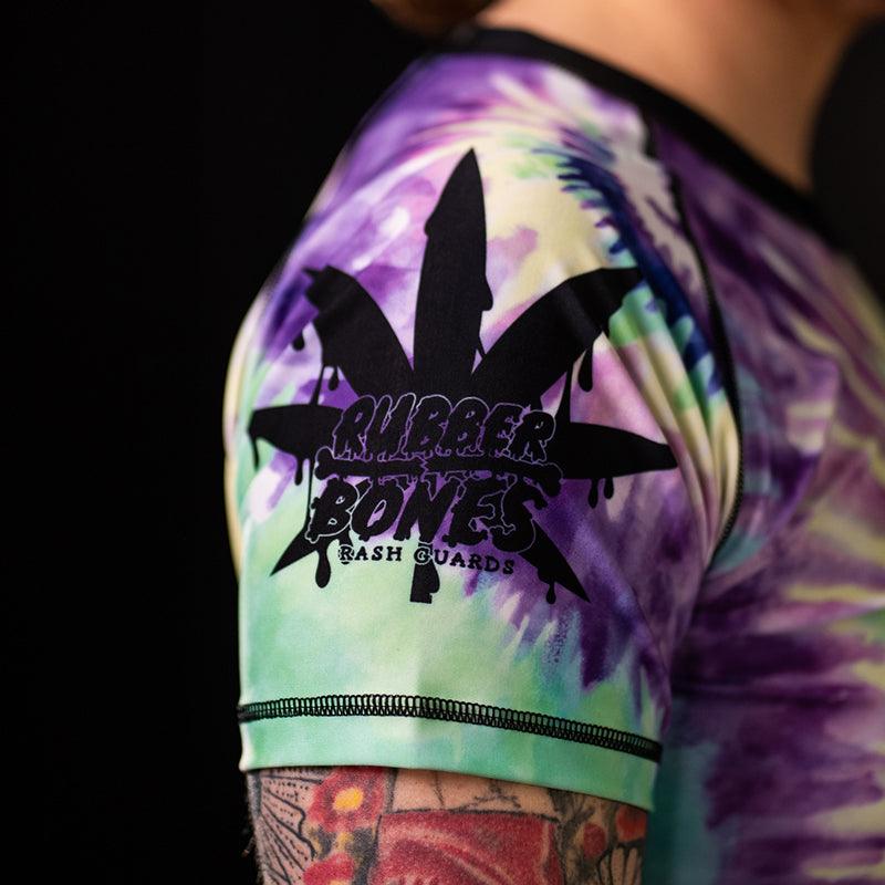 On-body left sleeve view of Women's Legalize Leg Locks Short Sleeve Rash Guard with Rubber Bones logo.