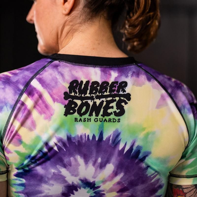 On-body right sleeve view of Women's Legalize Leg Locks Short Sleeve Rash Guard with Rubber Bones logo.