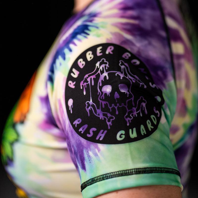 On-body left sleeve view of Women's Legalize Leg Locks Short Sleeve Rash Guard with Rubber Bones logo.
