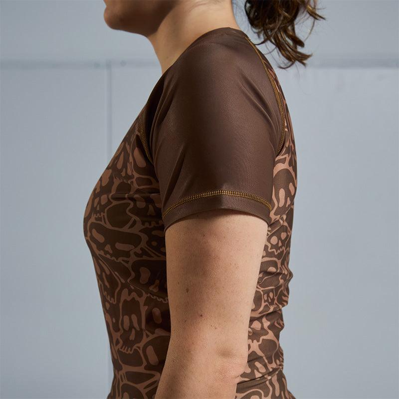 On-body side sleeve view of Women's Brown Ranked Rash Guard with blank sleeve design.
