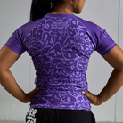 On-body back view of Women's Purple Ranked Rash Guard, showing the design and fit.