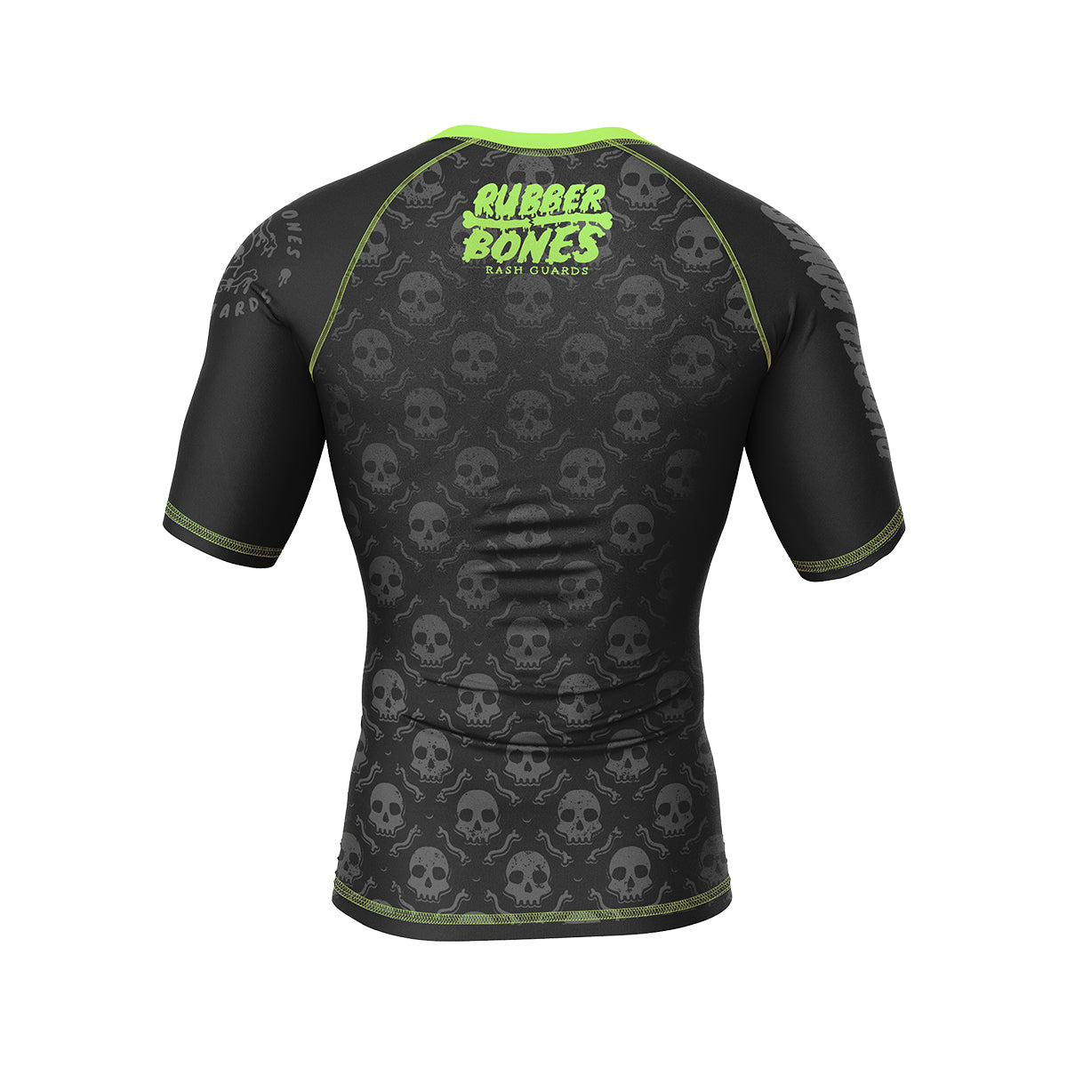 A black rash guard with an all-over pattern of subtle gray skulls. The Rubber Bones logo in neon green is centered at the top, standing out against the dark background.