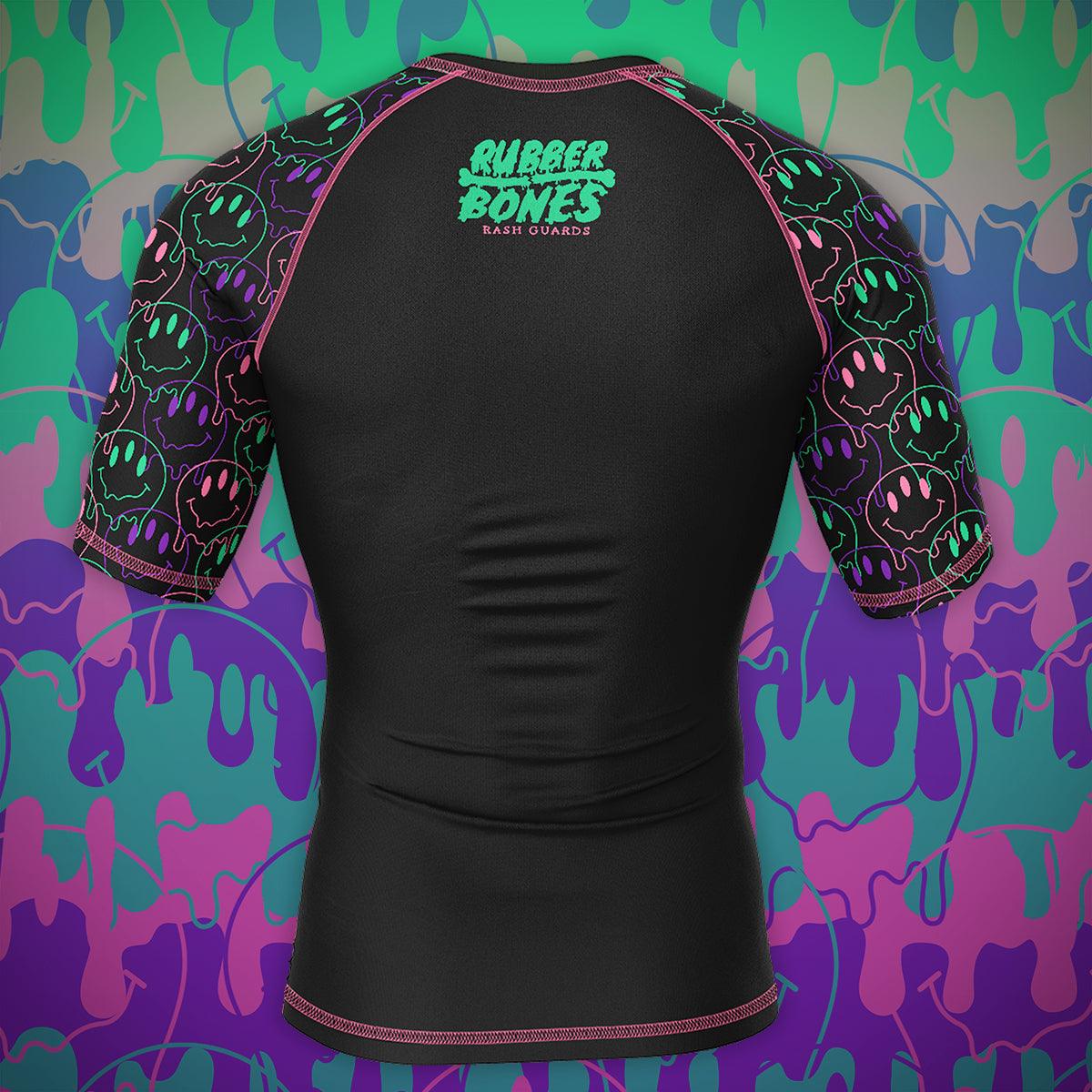 Mock-up of the back view of the Bubble Gum Rash Guard showcasing bold colors and dripping alien smiley face artwork.