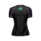 Black women's short-sleeve BJJ rash guard with neon green 'Rubber Bones Rash Guards' branding on the upper back. Sleeves are decorated with a colorful dripping smiley face pattern in green, pink, and purple.