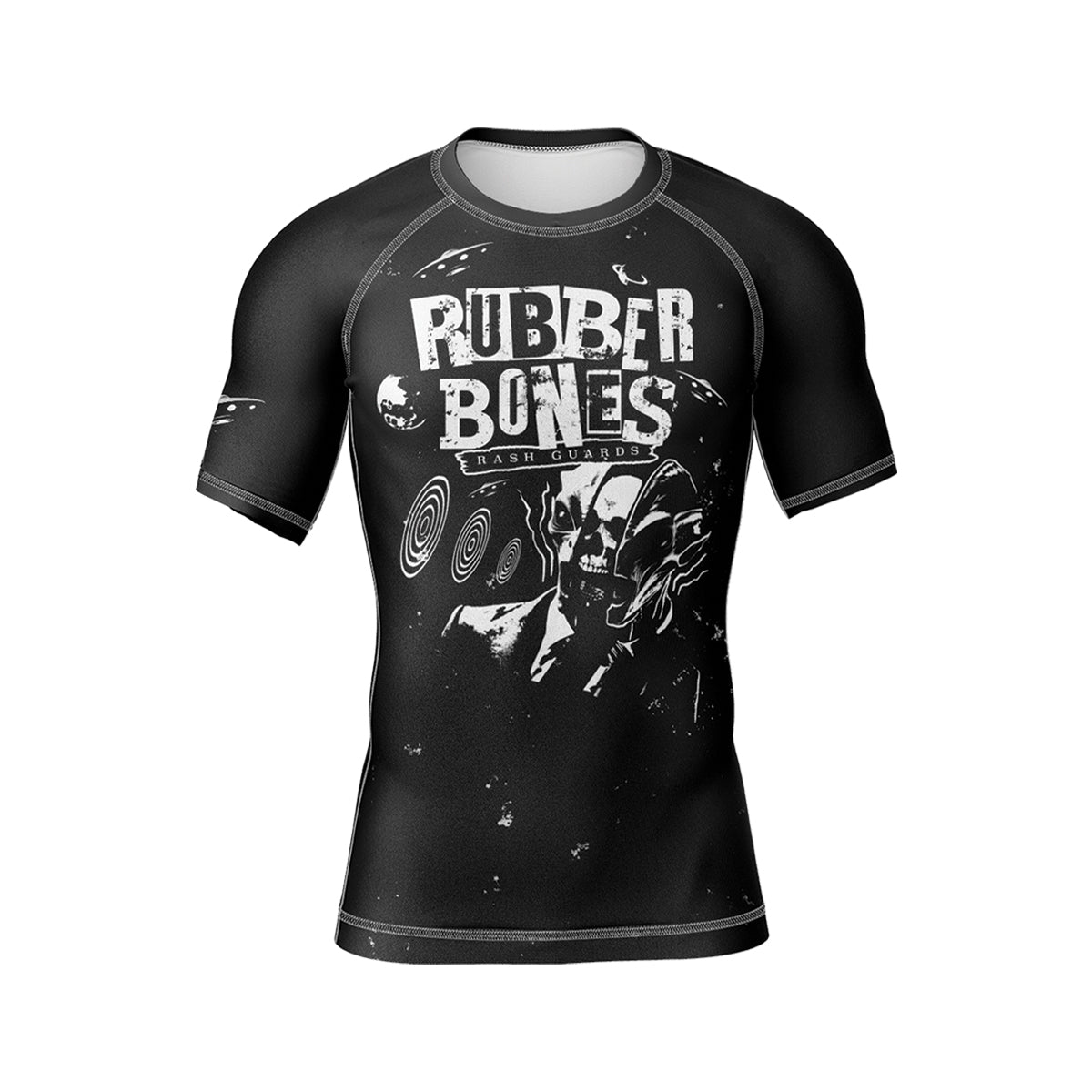 Black short-sleeve BJJ rash guard with a bold white 'Rubber Bones Rash Guards' logo across the chest. A surreal skull-faced figure in a suit with hypnotic spirals and cosmic elements adds an eerie, artistic touch.