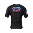 Back view of the Cotton Candy BJJ rash guard by Rubber Bones. Features a black base with the Rubber Bones logo in a pastel gradient of pink, purple, and blue. The sleeves have matching branding details for a sleek yet playful look.