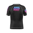 Back view of the Cotton Candy Kids BJJ rash guard by Rubber Bones. Features a black base with the Rubber Bones logo in a pastel gradient of pink, purple, and blue. The sleeves have matching branding details for a sleek yet playful look.