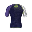 Dark blue short-sleeve BJJ rash guard featuring a subtle tone-on-tone illustration of a werewolf battling a mummy. Neon green 'Rubber Bones Rash Guards' branding is placed on the upper back. One sleeve has a white and green bandage-inspired design, while the other is deep purple with branding details.