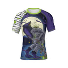 old, illustrated short-sleeve BJJ rash guard featuring a werewolf tearing into a mummy under a full moon. The dark blue and purple background creates a horror-inspired atmosphere, while one sleeve mimics mummy bandages and the other remains deep purple.