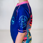 Close-up of the left sleeve of the Kids BJJ Invasion Rash Guard, featuring Rubber Bones logo.