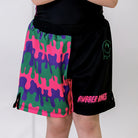 Bubble Gum Kids BJJ Shorts, front view, featuring black shorts with a purple, pink, and green drip pattern on the right side, and a green dripping smiley-faced alien with a pink Rubber Bones logo on the left side.