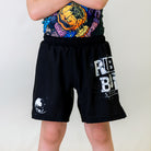 Kids BJJ Cosmic Truth Shorts, front view, featuring black shorts with white graphics, including the Cosmic Truth design and bold accents.