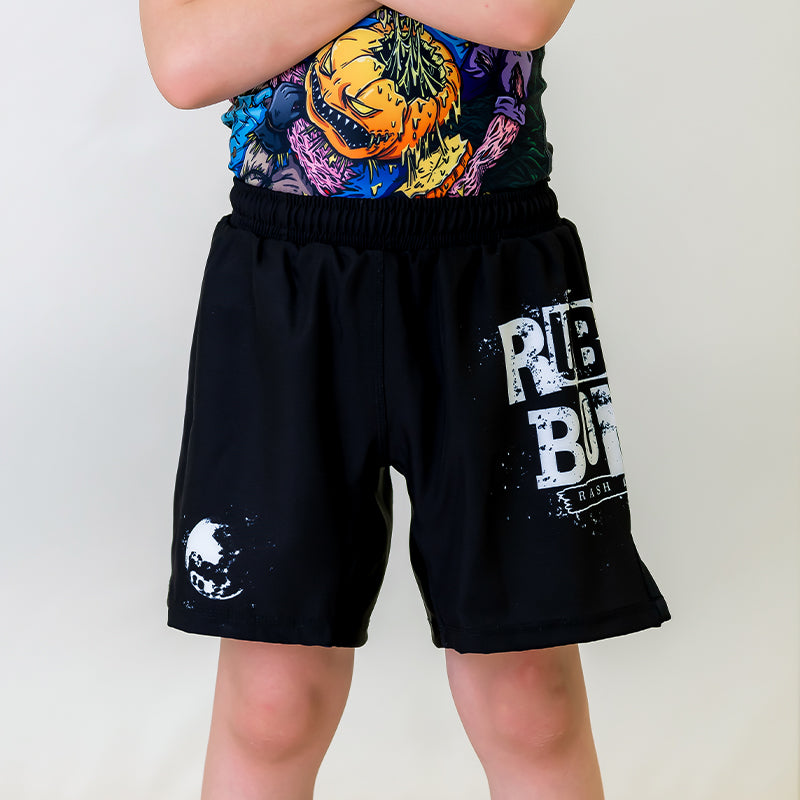 Kids BJJ Cosmic Truth Shorts, front view, featuring black shorts with white graphics, including the Cosmic Truth design and bold accents.