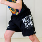 Kids BJJ Cosmic Truth Shorts, left side view, featuring the Rubber Bones logo in the Cosmic Truth design with white graphics on black fabric.