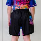 Cotton Candy Kids BJJ Shorts, back view, showcasing black shorts with pink and blue gradient accents.