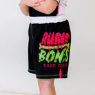 OG Kids BJJ Shorts, left side view, featuring pink and green Rubber Bones logo, pink side vent accent, and green stitching.